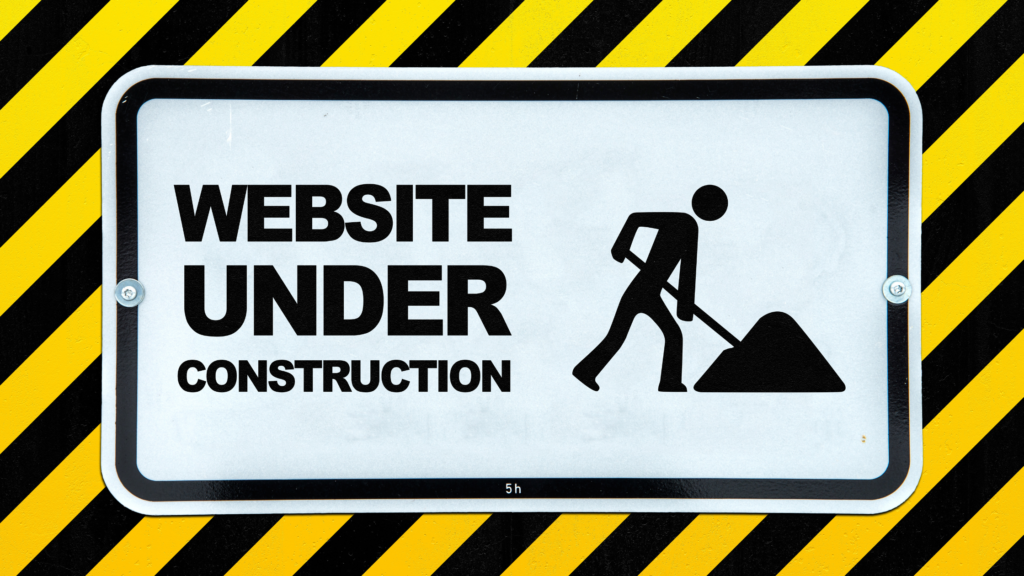 Website under construction warning sign with black and yellow hazard stripes